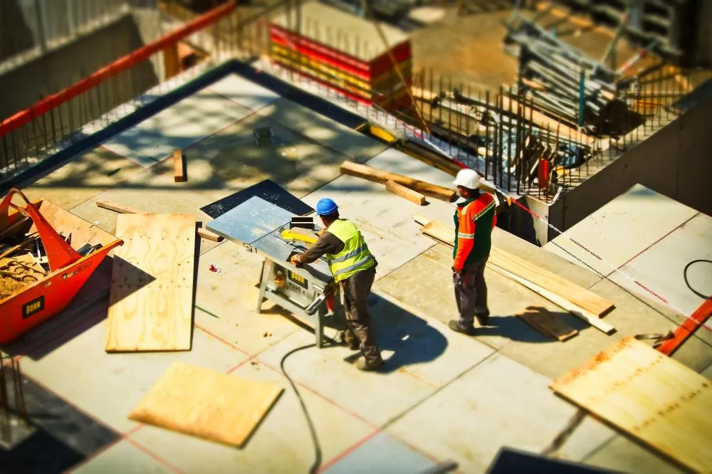 construction workers cutting wood